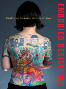 a woman's back covered in tattoos with the words in red emboded resistance
