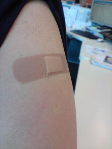 photo of a person's arm with a band-aid on it