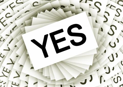 A spiral of white cards, each with the word "Yes" in black text