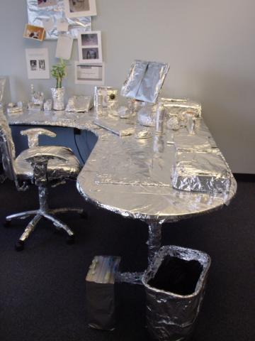 photo of office furniture covered in foil as a prank