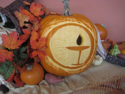 photo of a pumpkin carved to reveal a unitarian universalist chalice