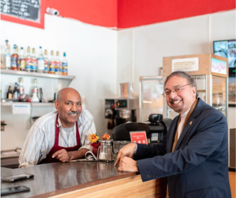 a photo of Dr. Bruce Corrie (on right) with a local cultural business owner