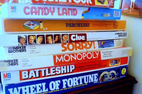 photo of a stack of traditional board games in boxes.