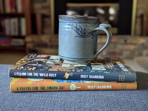 photo of a stack of two small books with a mug on top in a cozy living room setting