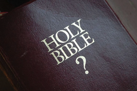 photo of the cover of an altered Bible, with gold lettering that reads, "Holy Bible?"