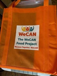 an orange grocery bag with the WeCAN logo on it