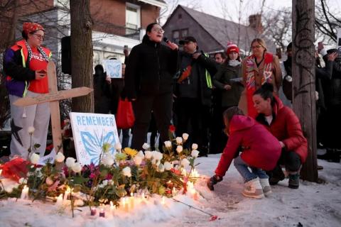 A girl places a flower at the site of Renee Nicole Good’s death at 34th Street and Portland Avenue, Wednesday, Jan. 7, 2026, in Minneapolis, Minn.