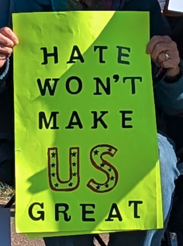 protest sign with text that reads, "Hate won't make US great"